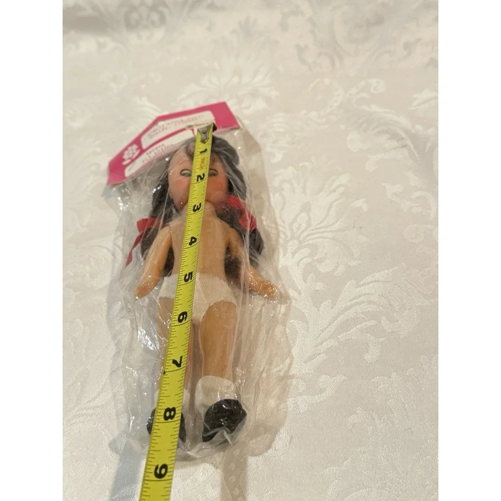vintage 8-inch doll from Frank's with movable eyes, braids, and white panties.